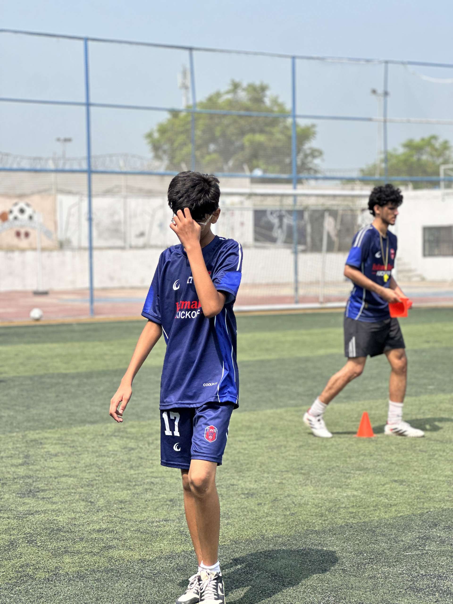 Number 17 running across the pitch during a session