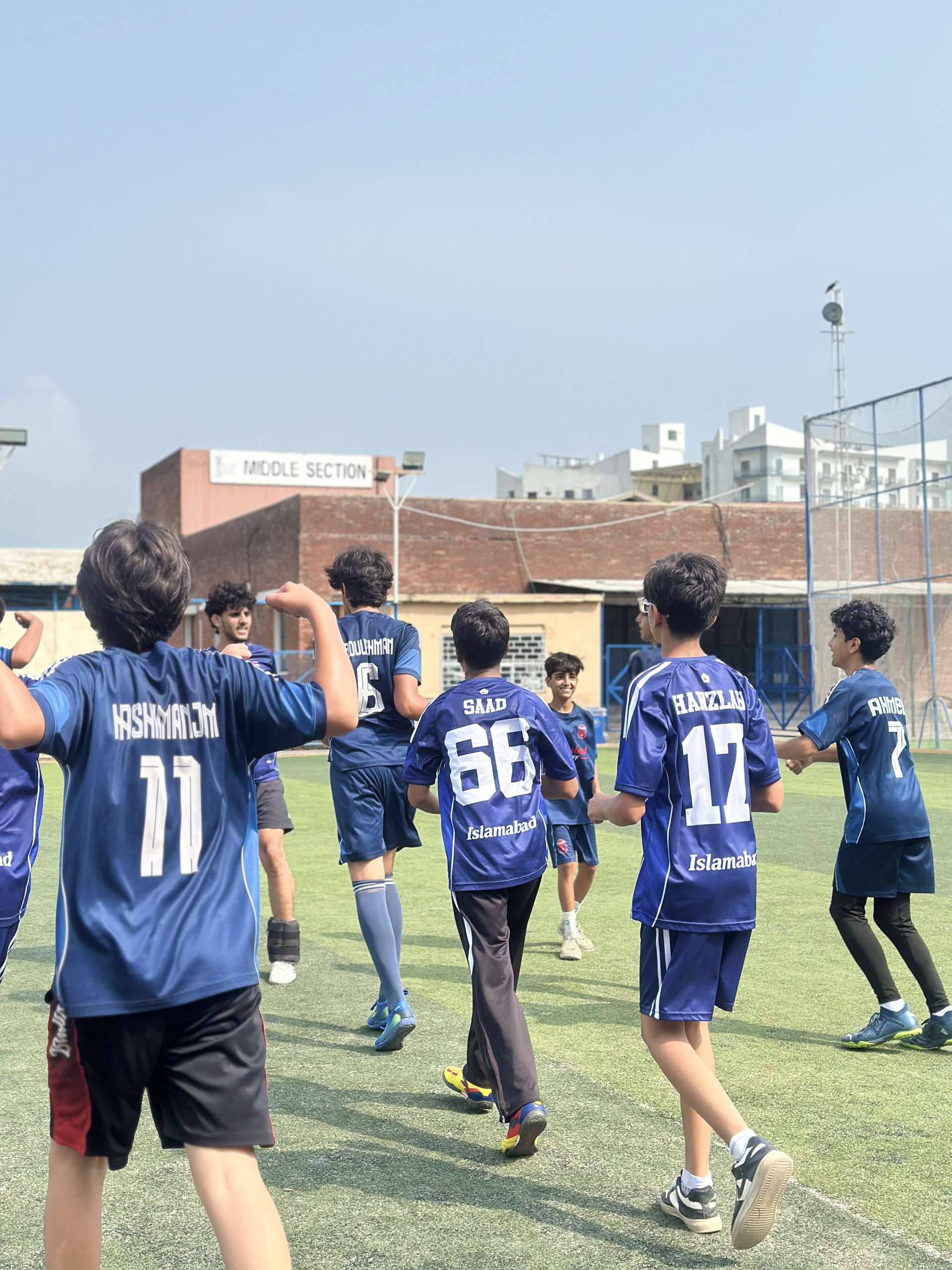 TWA FC players celebrating together after a goal