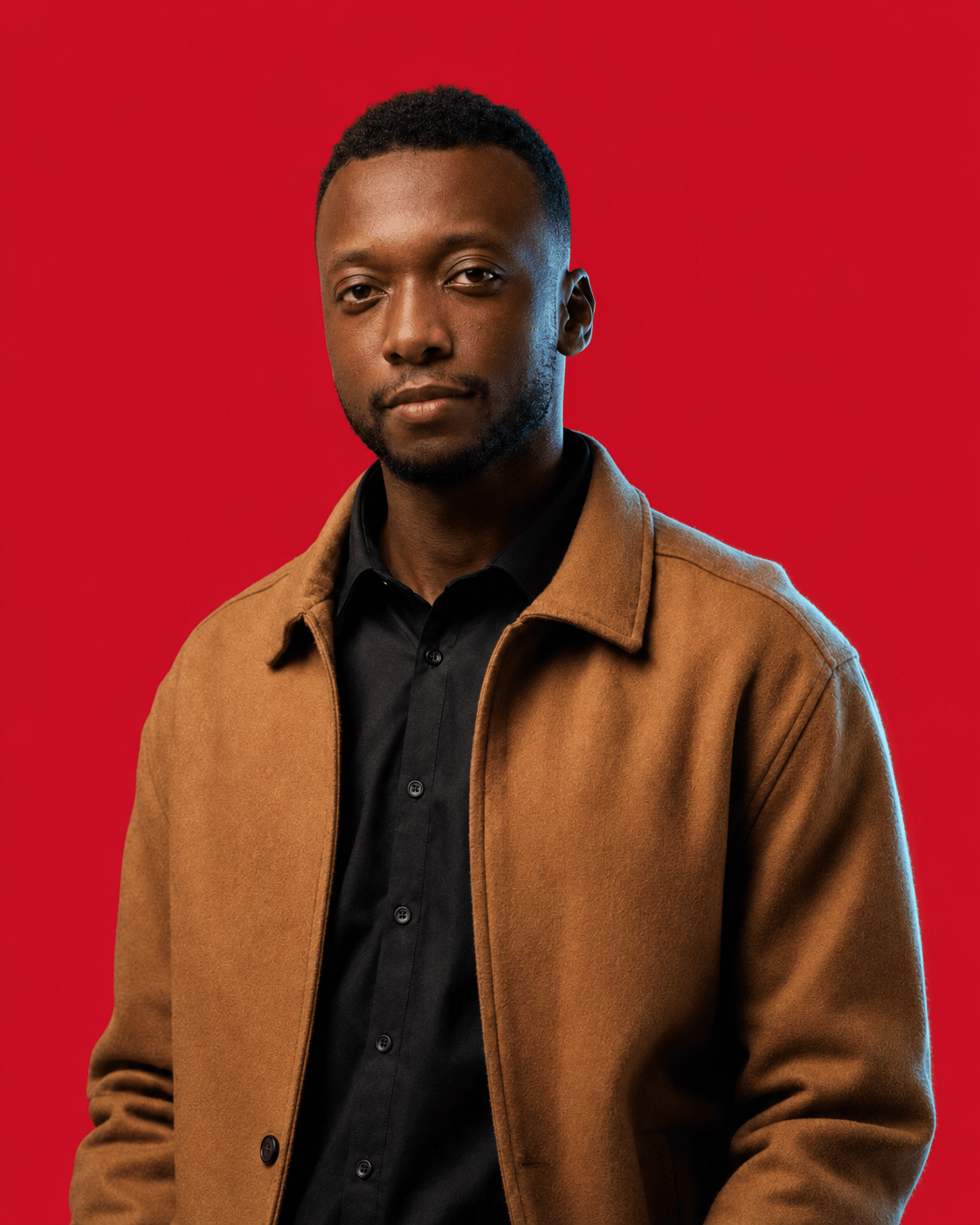 Asim, founder and head coach of TWA FC, photographed against a crimson ground