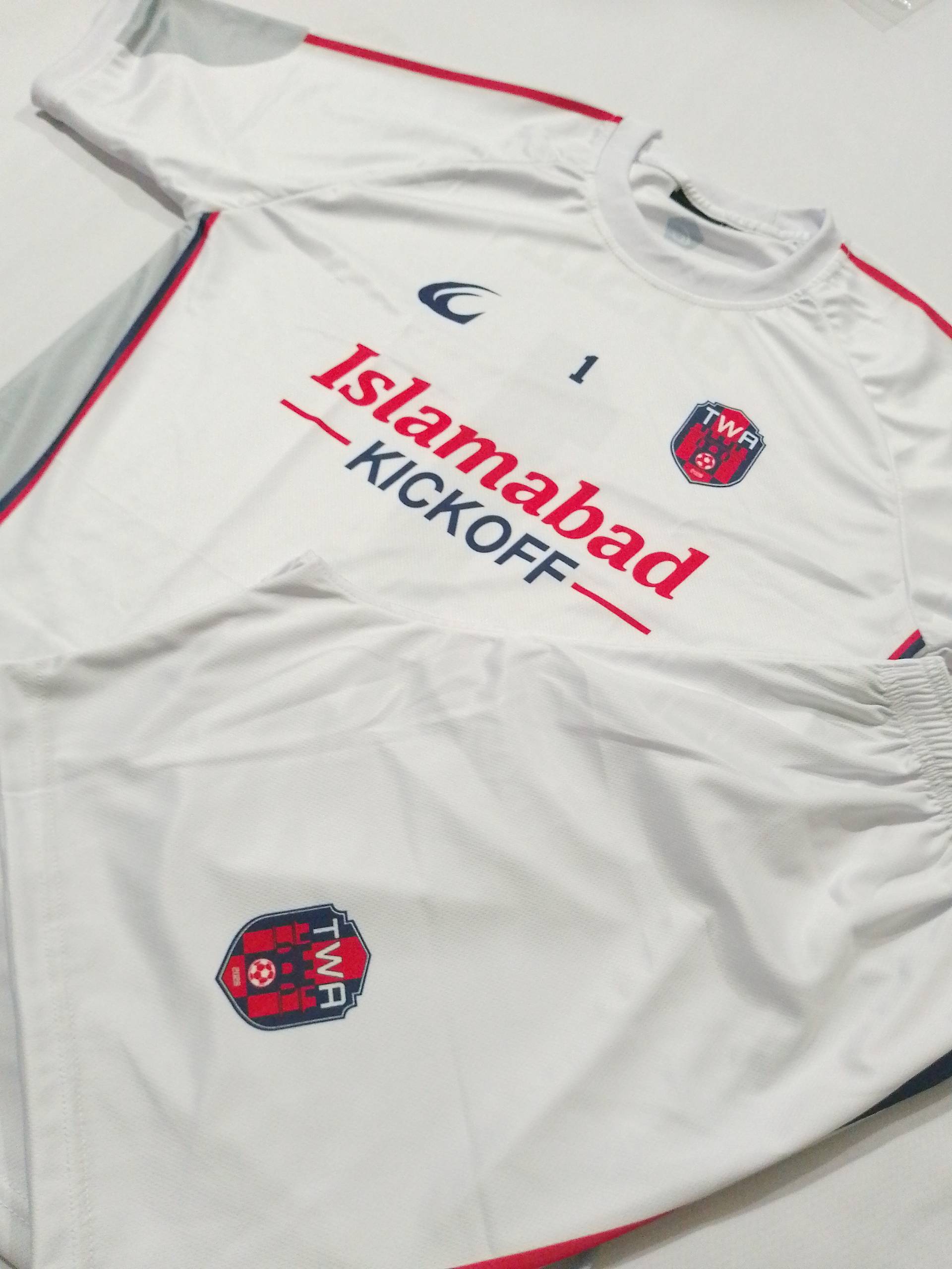 The white away shirt and shorts stood upright side by side