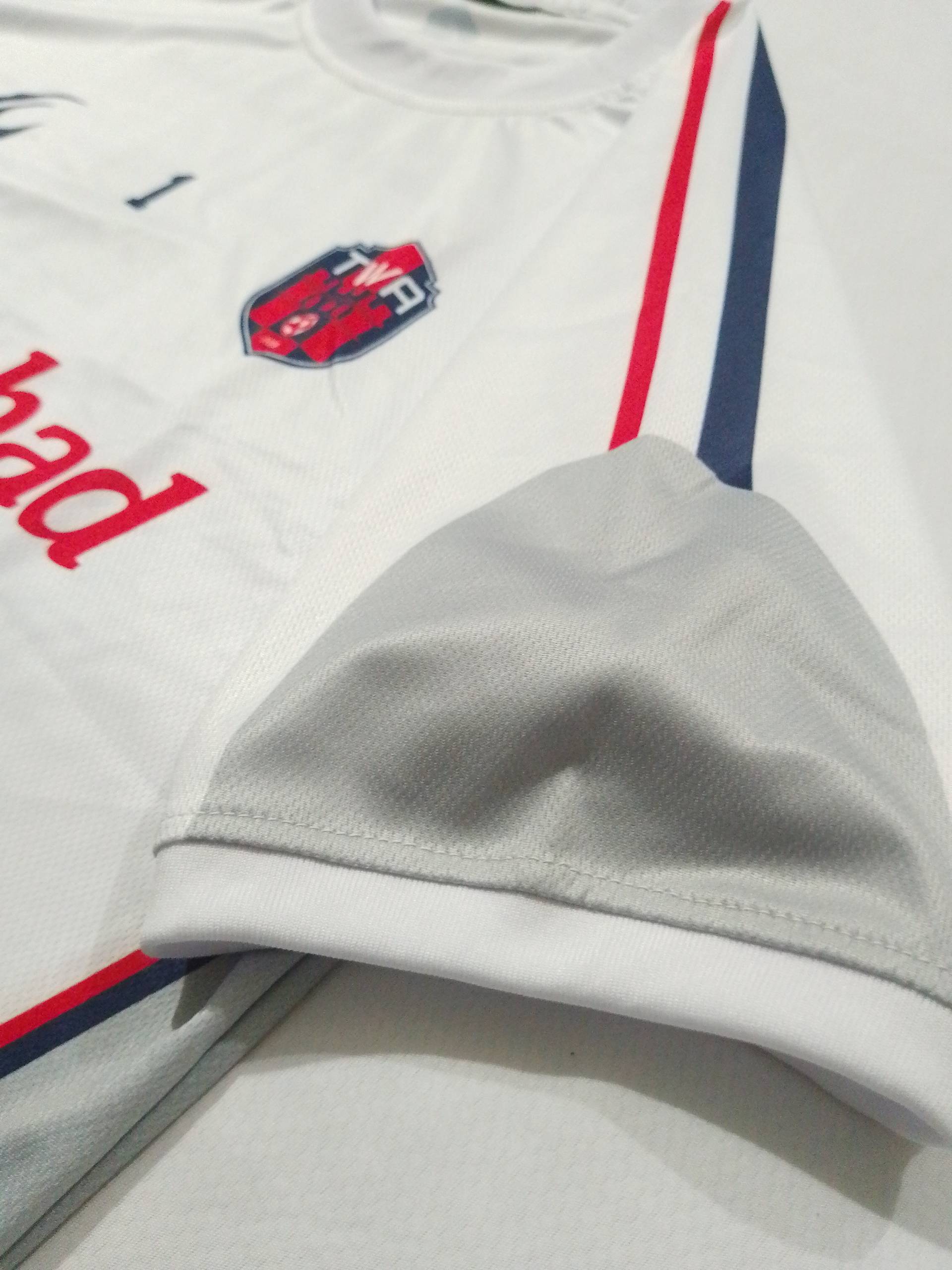 Macro shot of the contrast trim stitched into the white away shirt