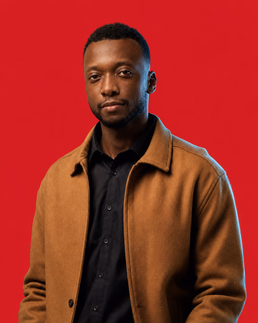 Asim, founder and head coach of TWA FC, photographed against a crimson ground