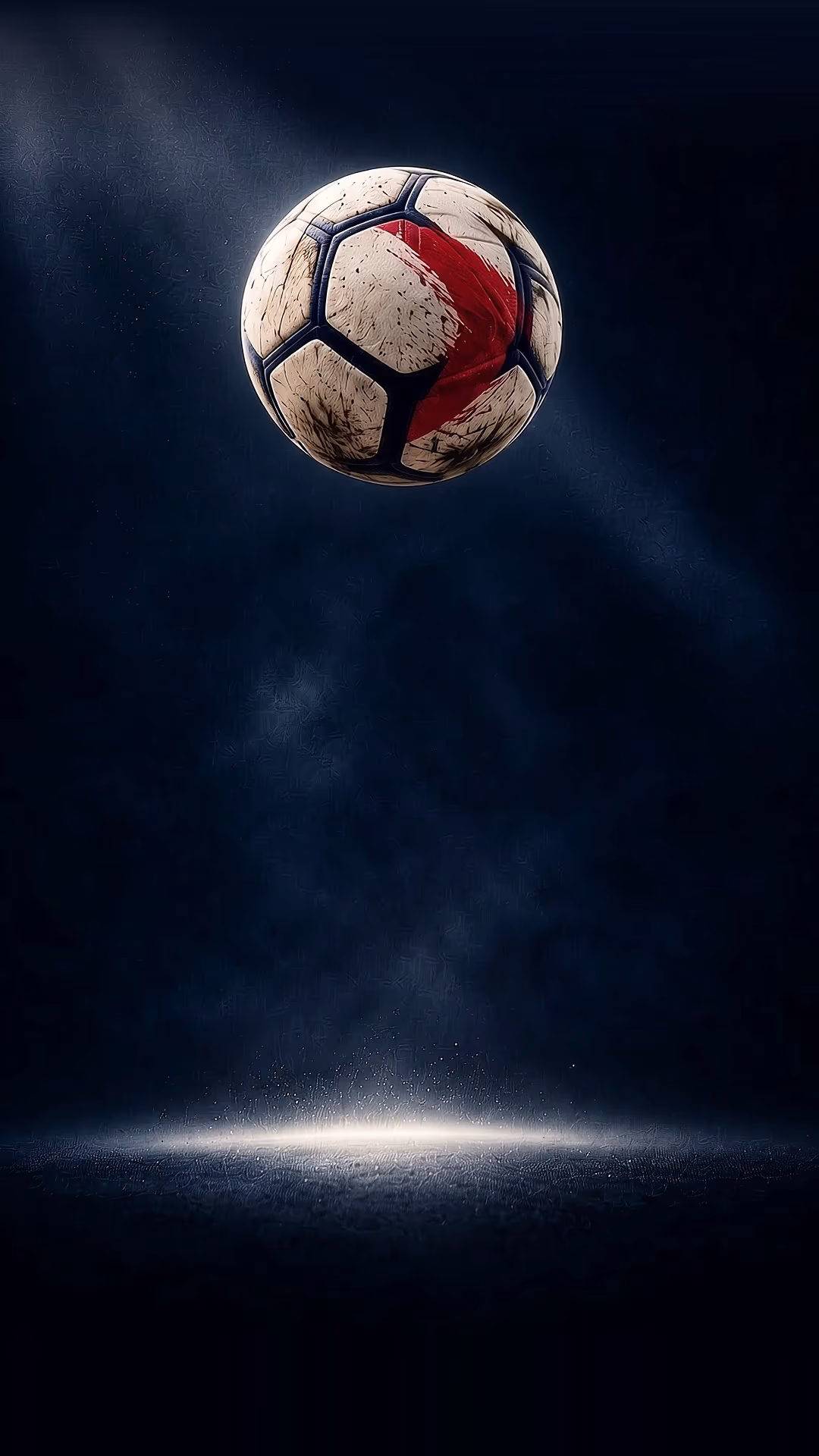 A match ball in mid-air under floodlights on a dark pitch