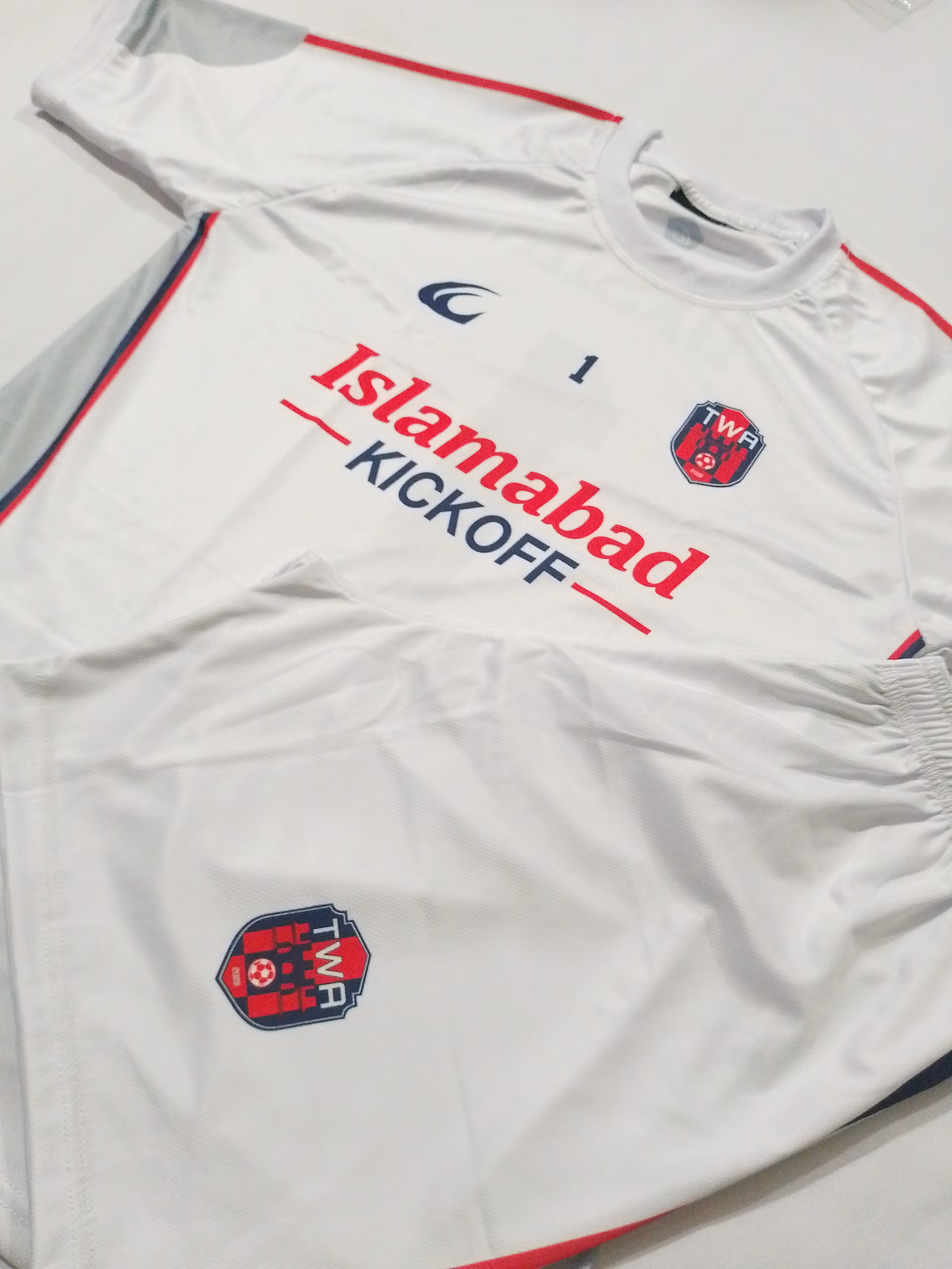 The white away shirt and shorts stood upright side by side
