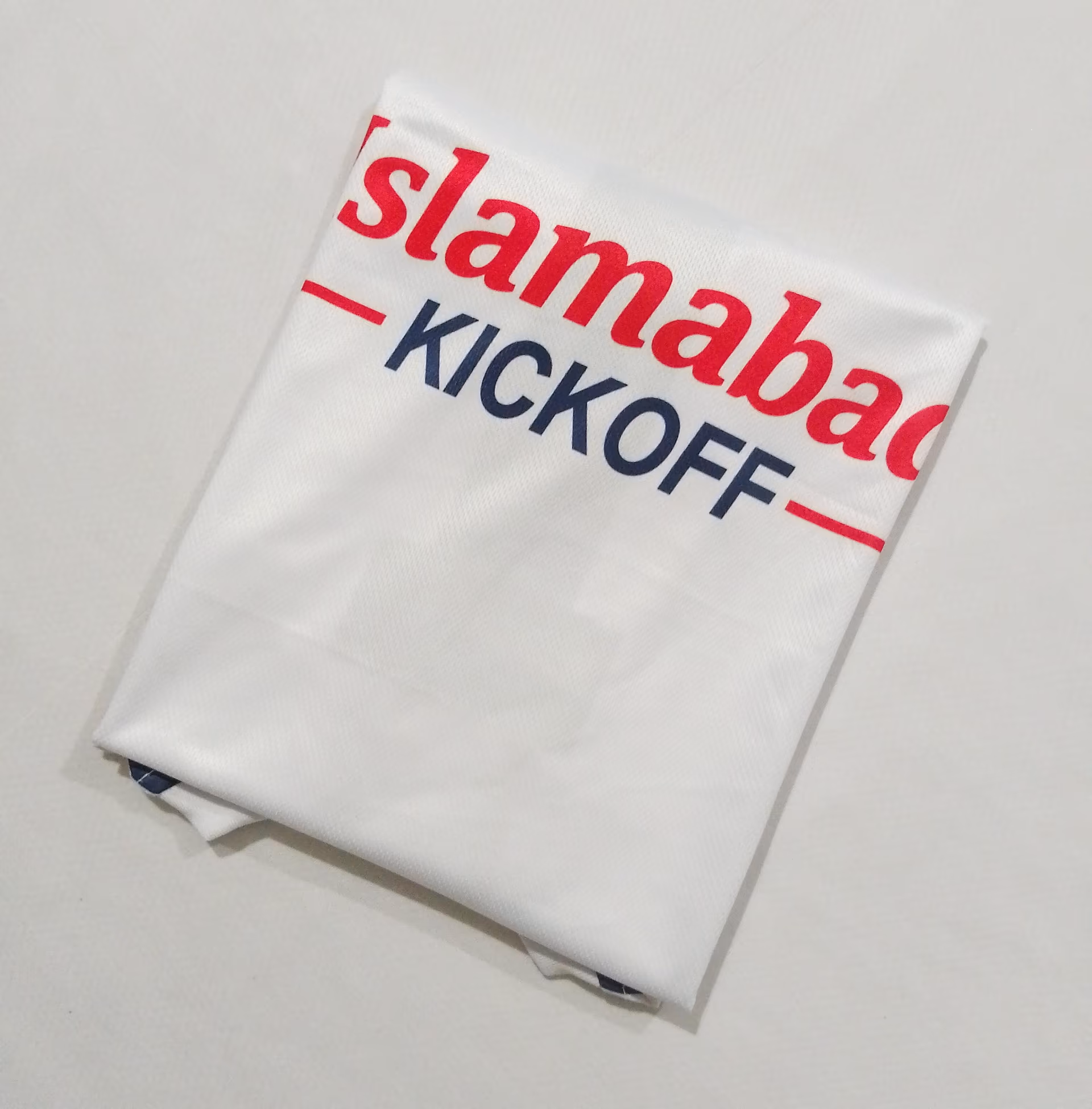 The back of the white away shirt, folded, showing the chest sponsor