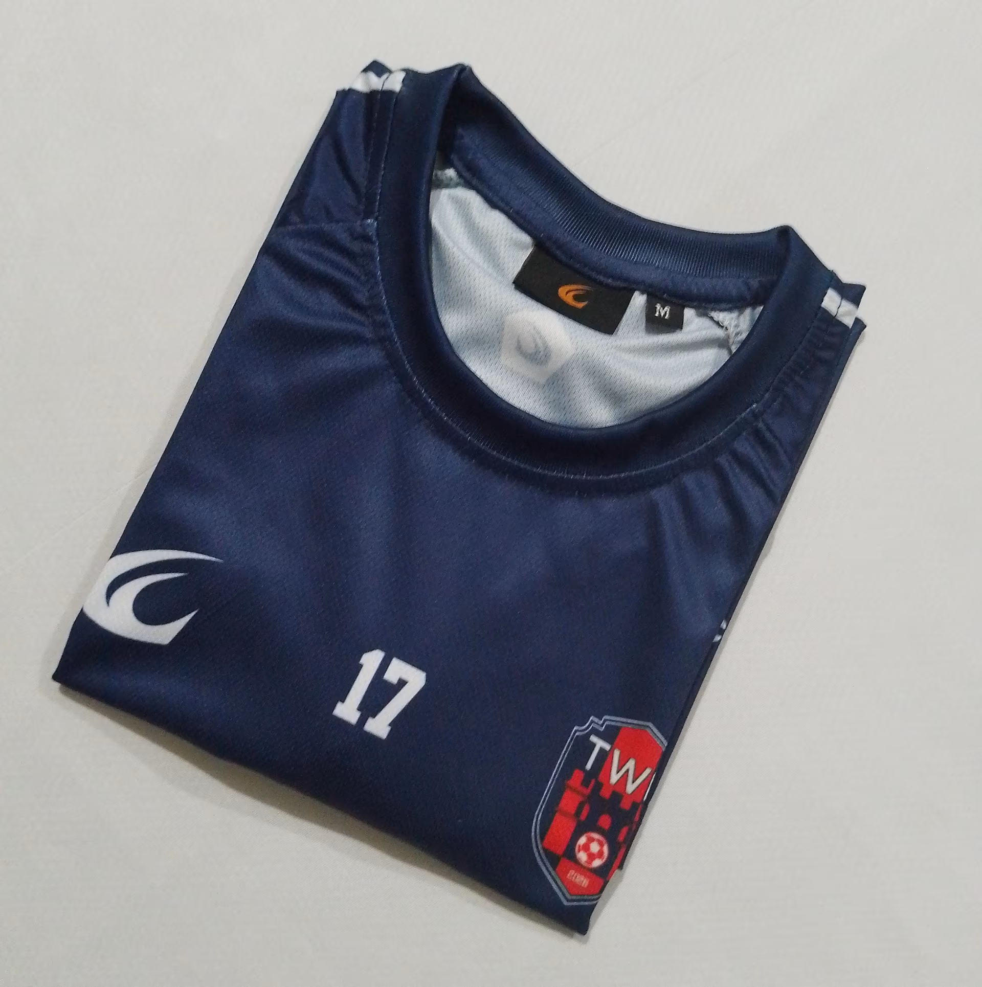 The back of the navy home shirt, folded, showing the number 17
