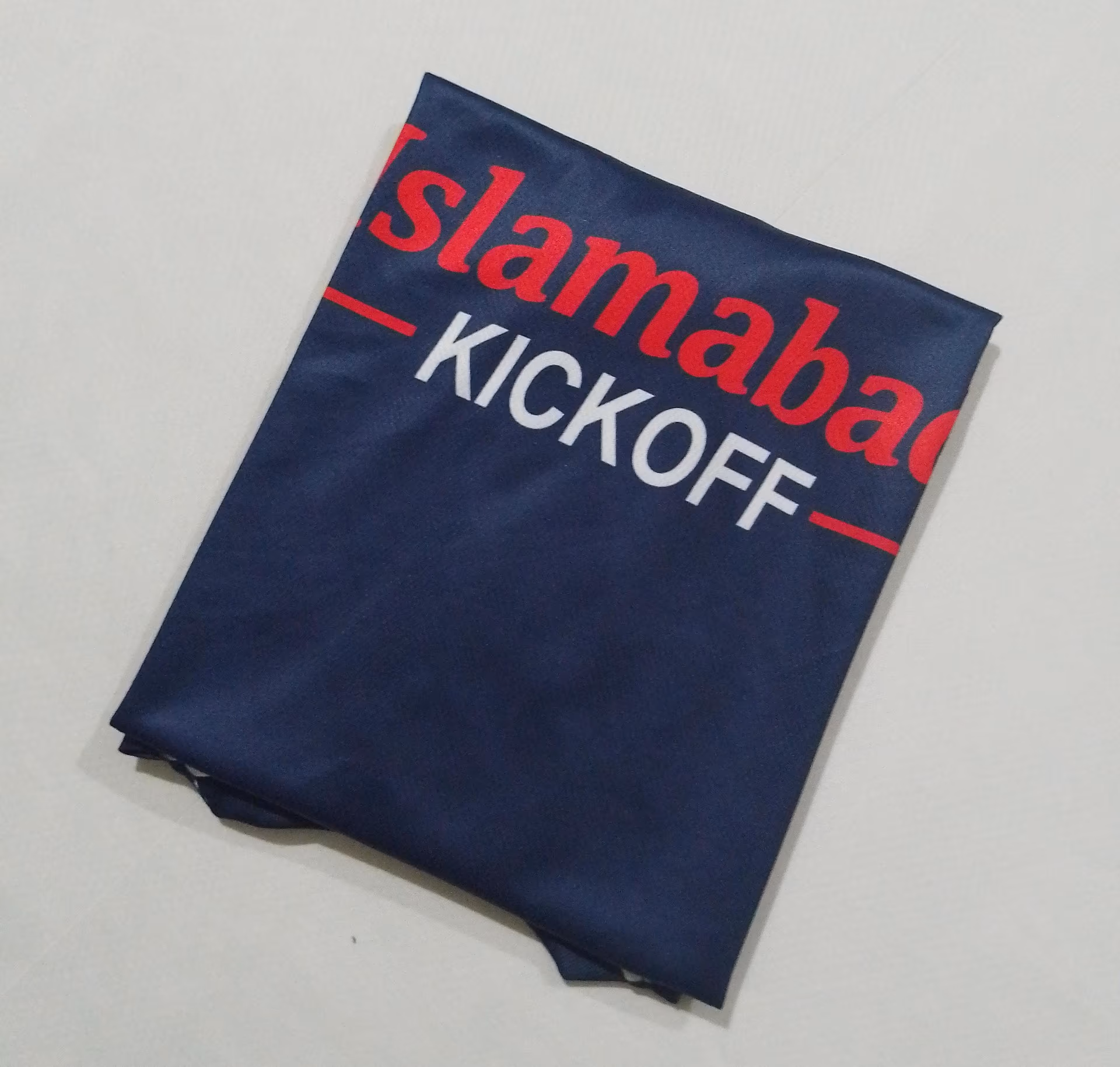The Islamabad Kickoff sponsor print across the chest of the navy shirt