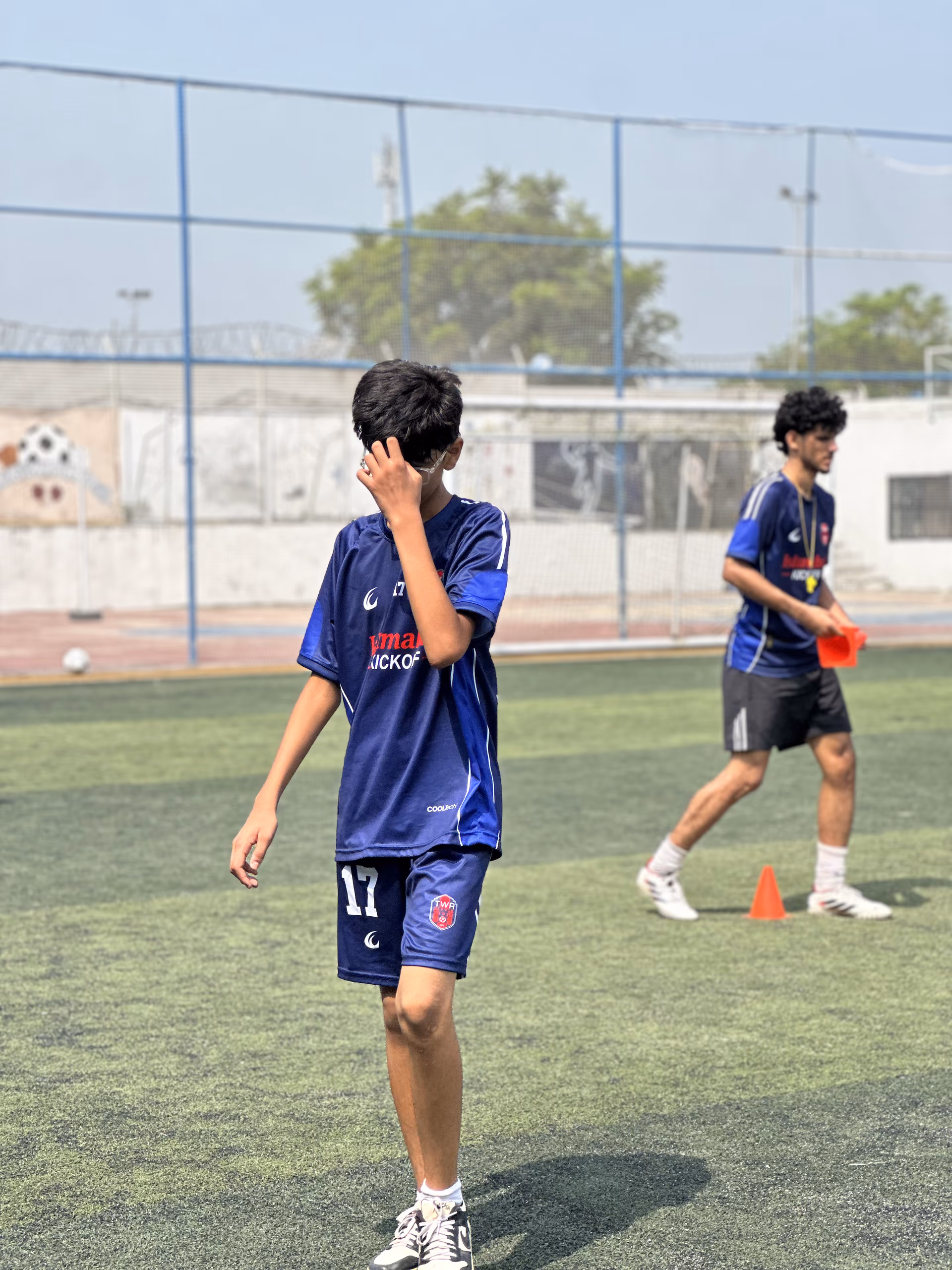 Number 17 running across the pitch during a session